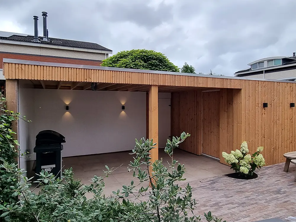 Installed Douglas Fir cladding boards with a triple slatted profile featured on the exterior walls and fascia trim of a contemporary outdoor garden canopy and patio area.