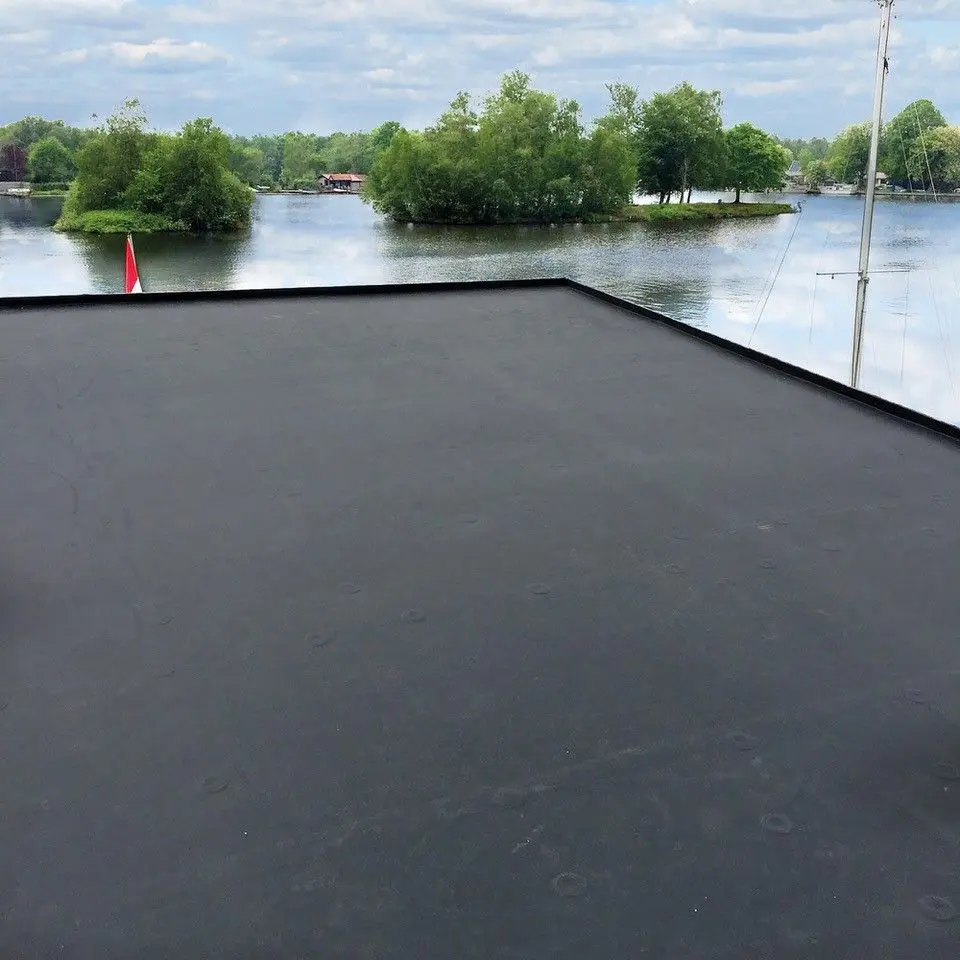 Flat roof installation detail for the Outdoor Pergola Willow Range 3000 overlooking a lakeside landscape.