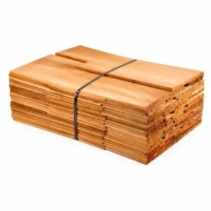 A bundled stack of Western Red Cedar roofing and cladding shingles, showing the natural grain variations and tapered profile of Blue Label No. 1 Grade timber.