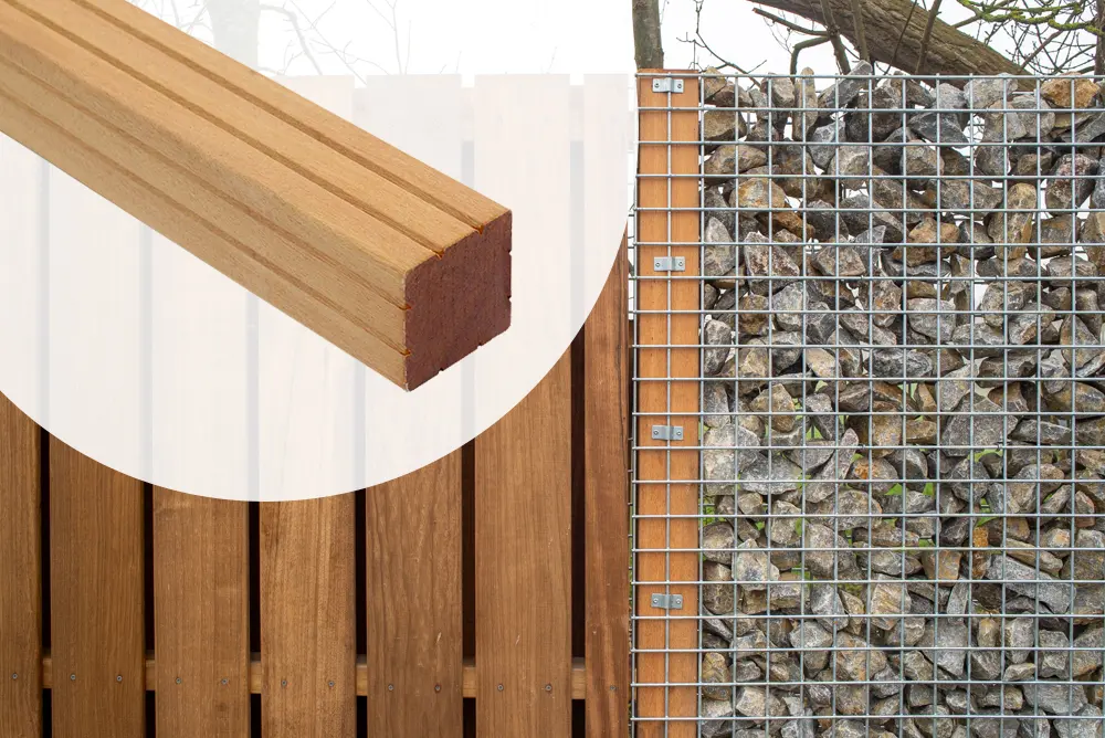 Structural installation view showing a rock-filled gabion wall supported by a Yellow Balau Timber Post PAO measuring 90x90mm with a 3000mm length next to timber fencing.