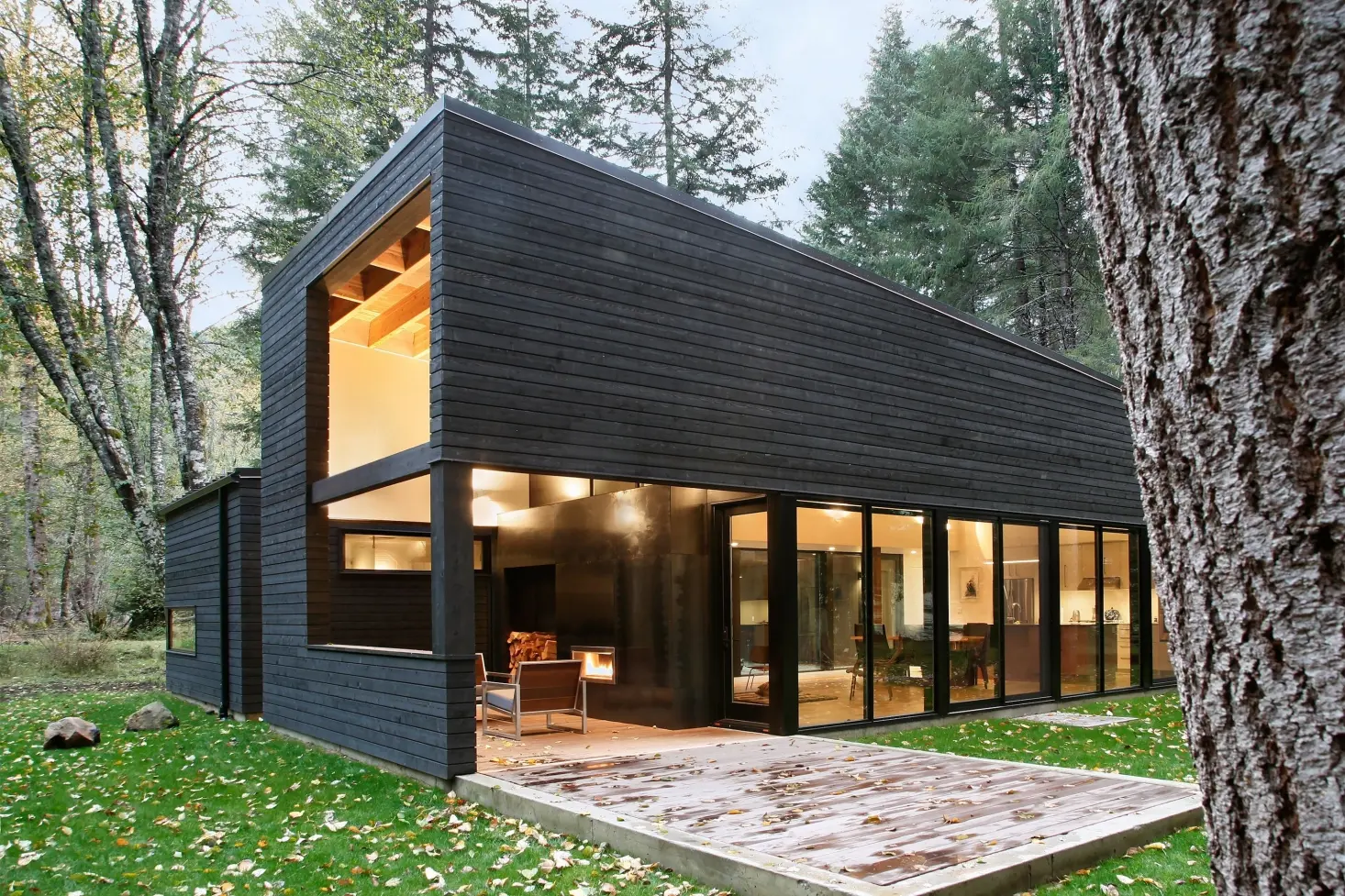 Modern forest cabin exterior featuring black Siberian Larch charred timber cladding board.