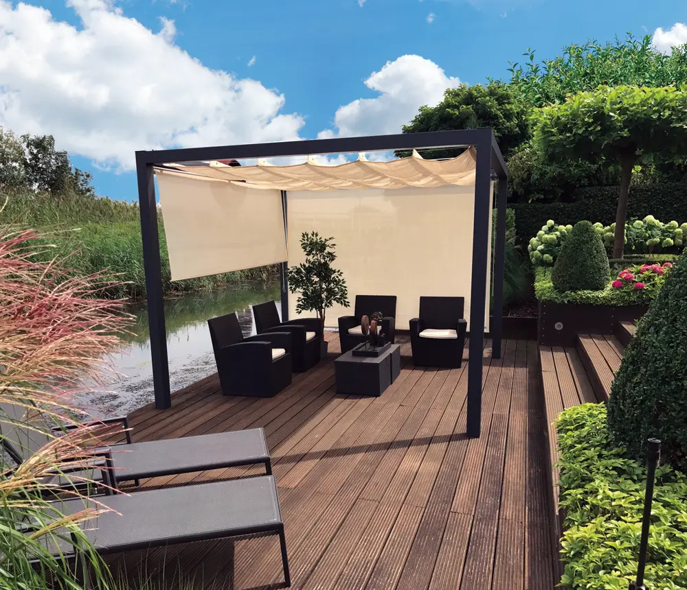 Black-stained Spruce timber posts supporting a luxury garden pergola canopy on a wooden decking patio next to a pond.