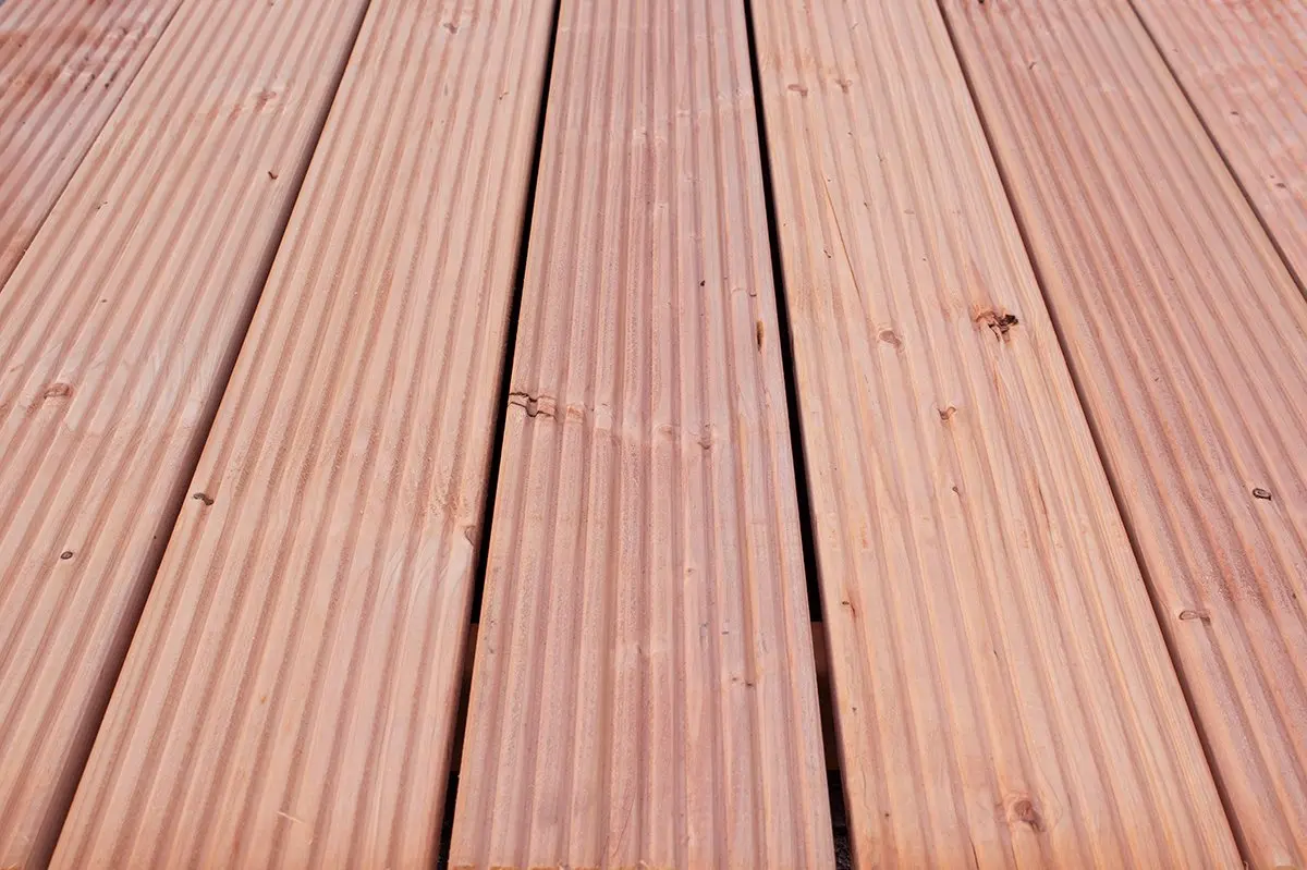 Laid pieces of Ecowood Decking Board Smooth Smooth profile showing wood grain texture.