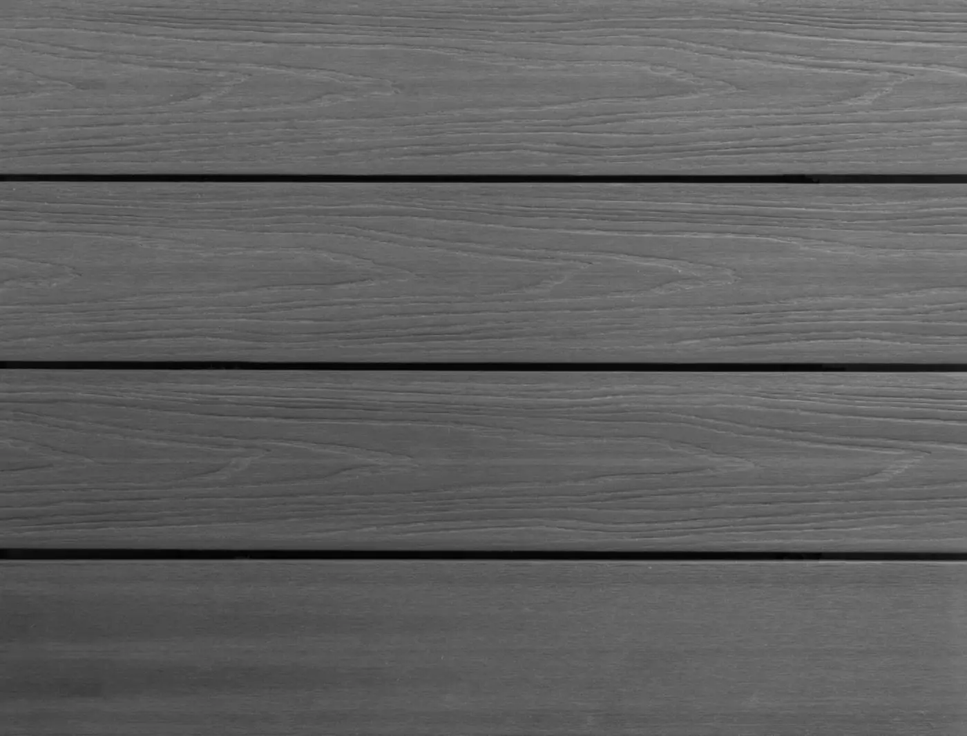 Flat, full-frame texture view of installed PuraShield round hole co-extruded composite decking boards in Dark Grey showing parallel gaps and a natural looking wood grain surface.
