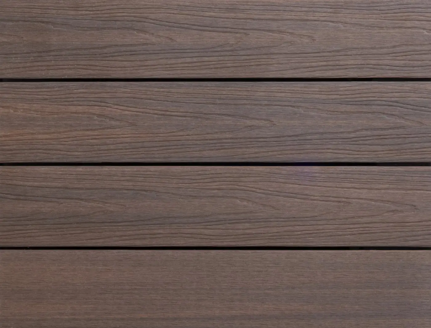 Close up texture panel view of installed PuraShield composite decking boards in Ipé showcasing the natural deep brown wood grain texture pattern.